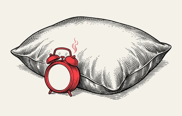 Gravură în tuș: o pernă cu un ceas deșteptător roșu